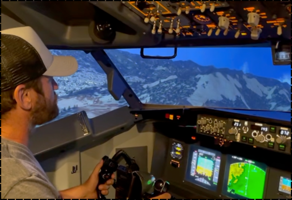 Interior view of Boeing 737 cockpit simulator with guest at the controls